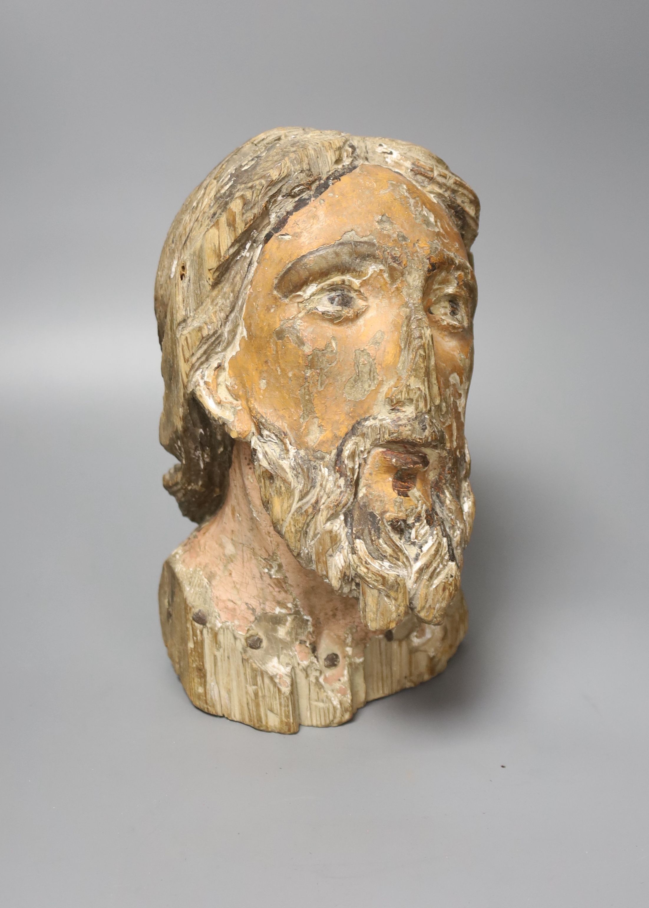 A 16th/17th century carved and polychrome painted pine head of a saint, 26cm